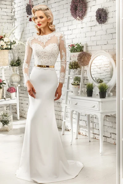 The beautiful  woman posing in a wedding dress