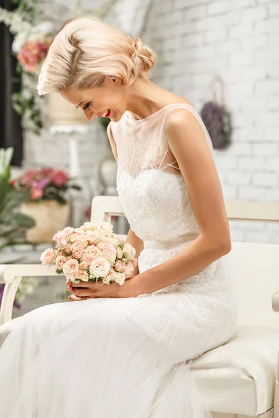 The beautiful  woman posing in a wedding dress — Stok fotoğraf