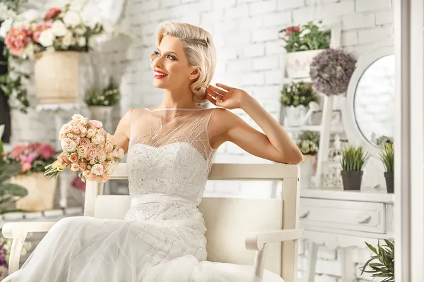 The beautiful  woman posing in a wedding dress