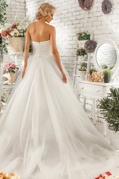 The beautiful  woman posing in a wedding dress