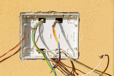 The box from the electrical panel is built into the wall, connecting the electrical wires to the switches. Electricity supply to the house or apartment.