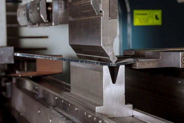Böjning av plåtdelar med hjälp av en bockningsmaskin. Tillverkning av metalldelar. — Stockfoto