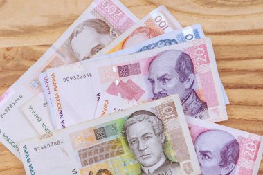 Croatian kunas, various bills on a wooden table. The national currency of Croatia. Croatian money.