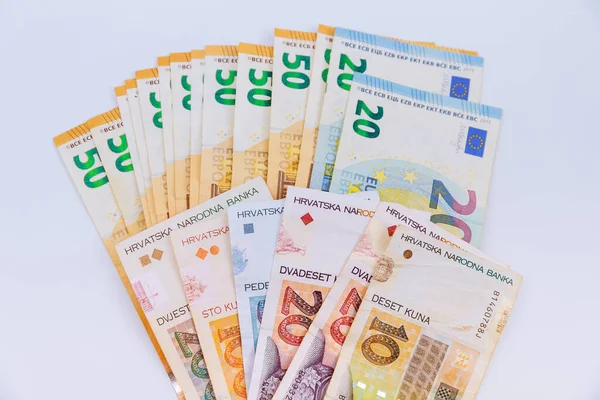 Kunas and euros of various denominations on a white background. Croatian and European currency. Lots of money.