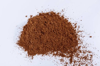 Pile of peat scattered on a white background. Place for text.