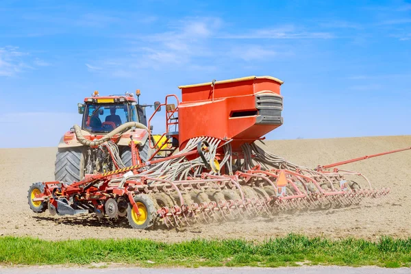 Red Tractor Sows Grain Seeder Field Modern Technology Works Field — Fotografia de Stock