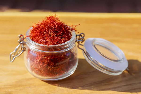 Many Red Stamens Jar Wooden Background Dry Spices Jar — Fotografia de Stock