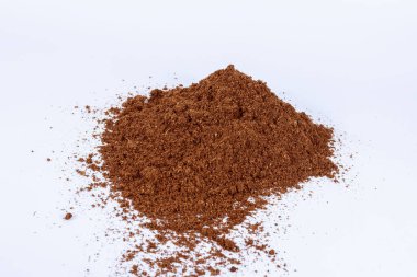 Pile of peat scattered on a white background. Place for text.