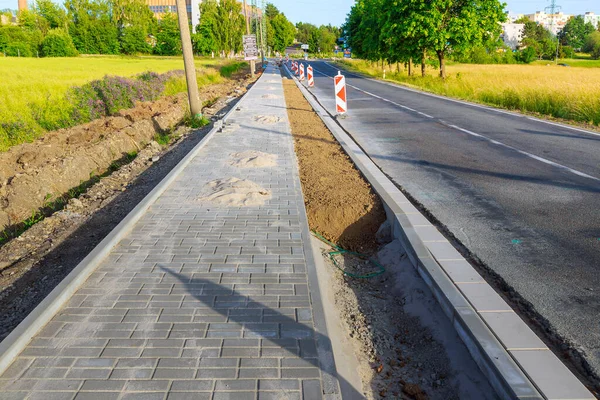 Repair of sidewalks in rural areas, laying paving stones on the sidewalk and filling pits with soil.