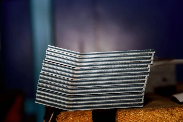 A stack of sheet metal products after processing on a bending machine.