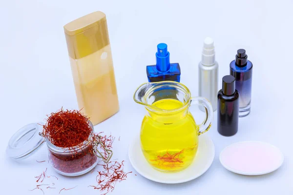 Saffron stamens and tea and cosmetics on a white background. Cosmetics made from saffron.