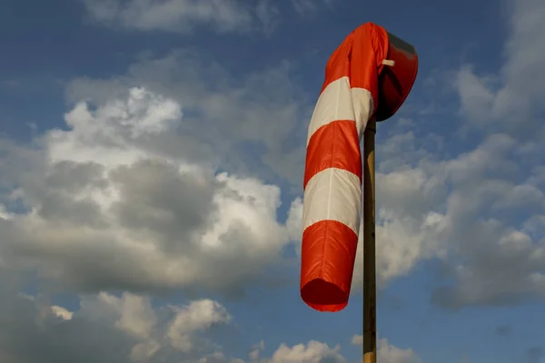 Windsock wind indicator shows that there is no wind. Windless weather.