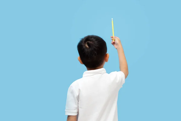 Kid Hoding Pencil Pointing Upwards Wearing White Shirt Back View — Fotografia de Stock