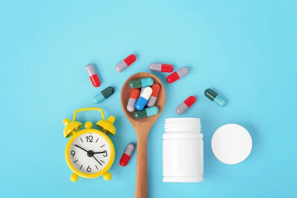 Medicine Time Concept Capsule Pills Spoon Alarm Clock Blue Background —  Fotos de Stock