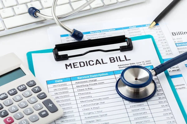 Medical bill concept with calculator and stethoscope on white desk