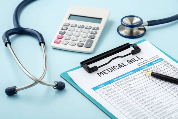 Medical bill with pen and stethoscope on blue background