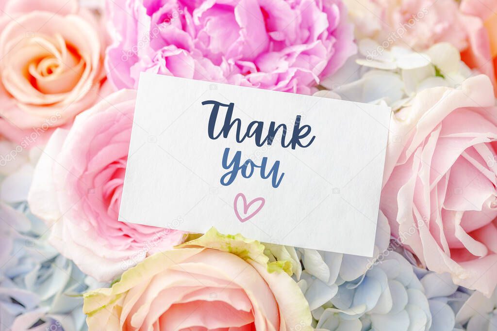 Thank you text with heart on card with blossom pastel flower background