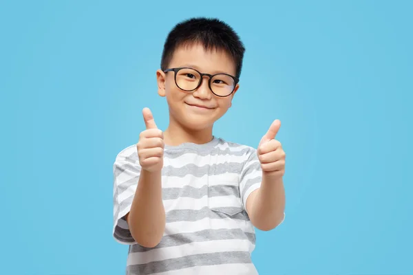 Happy Kid Showing Thumbs Wearing Eyeglasses Tshirt Blue Background — Zdjęcie stockowe