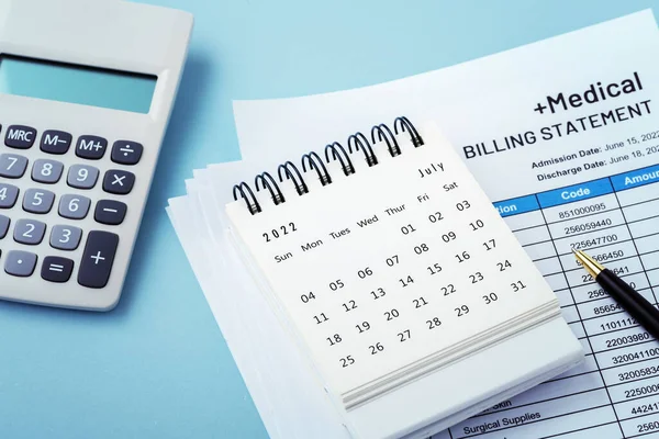 Calendar on hospital bill with calculator, medical payment plan on blue background