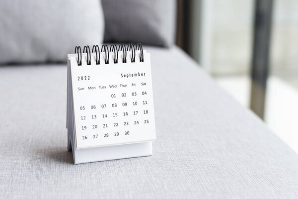 Calendar on fabric sofa near window, business event  planning schedule