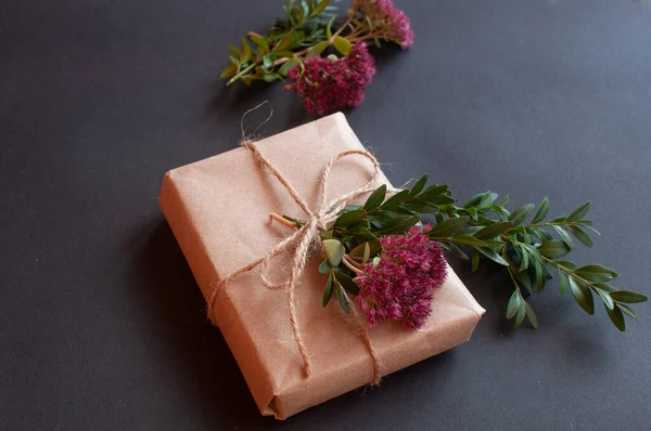 Řemeslná Dárková Krabice Uzlem Přírodní Růžové Malé Květiny Černém Pozadí — Stock fotografie
