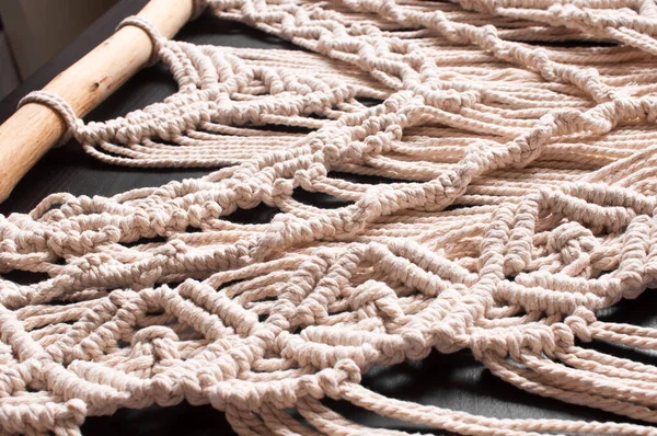黒を基調としたベージュの天然糸で手作りされたマクラメを織るスタイルの装飾の一部 — ストック写真