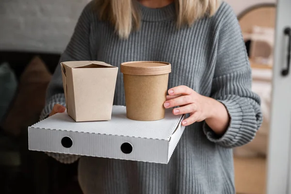 Zero waste lunch boxes, food delivery box with pizza in the girl's hands. Lunch to order at home