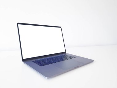 Öndeki beyaz masadaki dizüstü bilgisayar