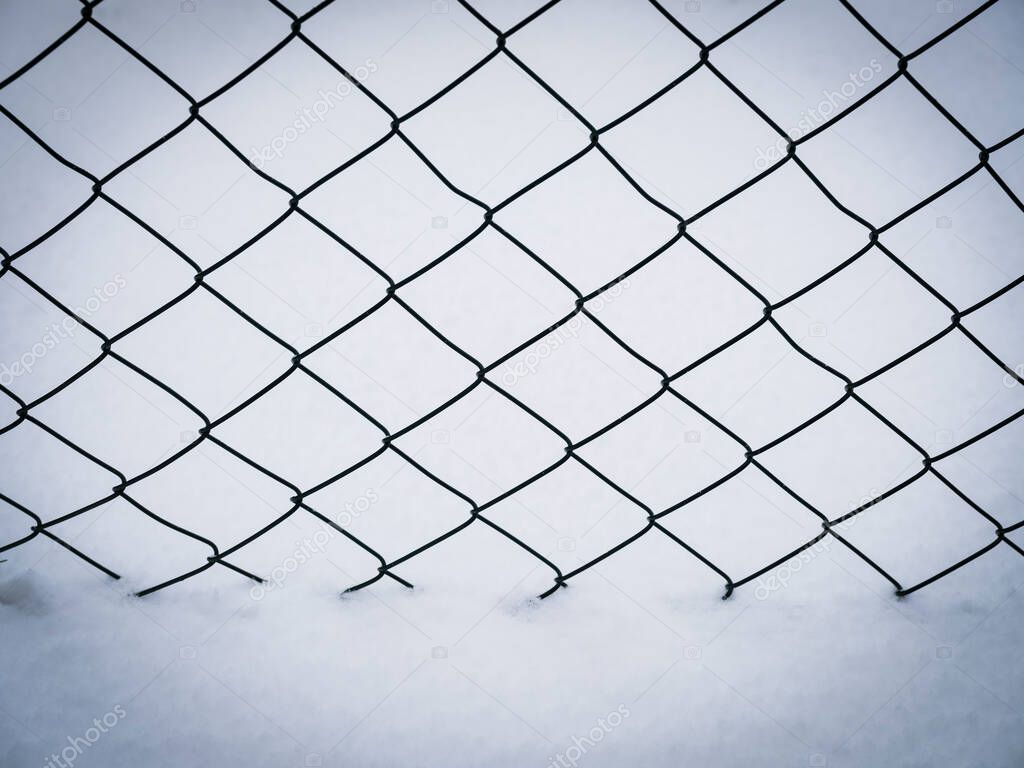 snow covered wire mesh winter background