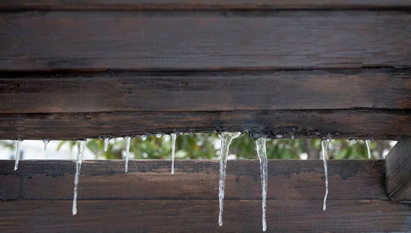 Small Icicles Wooden Background — Stock Fotó