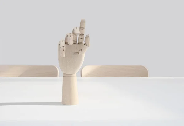 wooden hand on office desk, front view