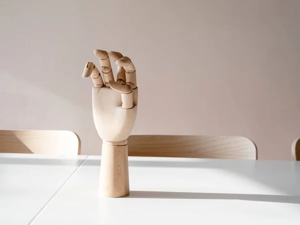 wooden hand on office desk, front view