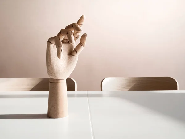 wooden hand on office desk, front view