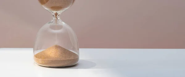 sand watch on wooden table. Front view