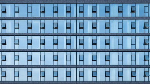 Office windows facede. Blue glass and steel frame,background texture. front view