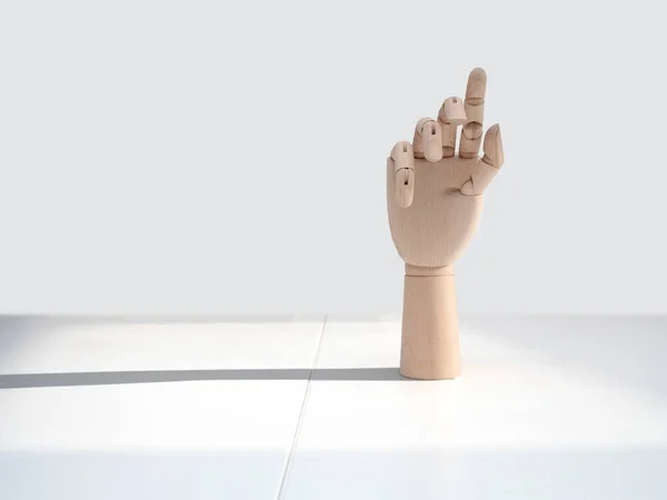 wooden hand on office desk, front view