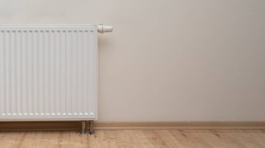 Modern white radiator with thermostat