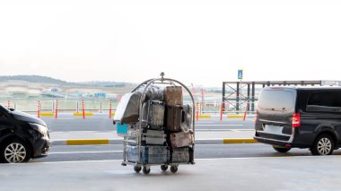 Porter cart with suitcase at the airport, front view