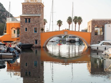 yachts and motor boat in marina port, front view