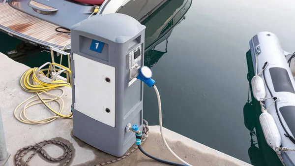 Charging station for boats, electrical outlets to charge ships in harbor. Electrical power sockets bollard point on pier near sea coast. Close up