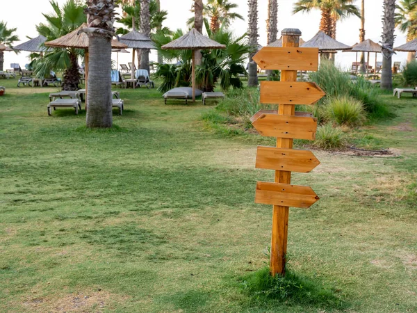Wood signs on the beach. Direction signpost on sea background. front view