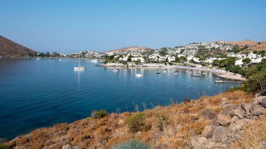 View of Bodrum Beach, Aegean sea, traditional white houses, flowers, marina, sailing boats, yachts in Bodrum town Turkey. Front view
