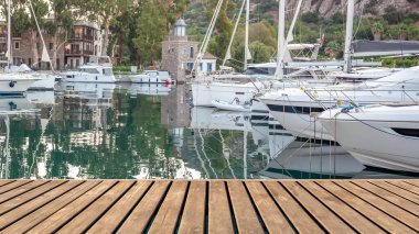 Empty wooden platform on yachts and motor boat in marina port, Aspat Marina. Front view