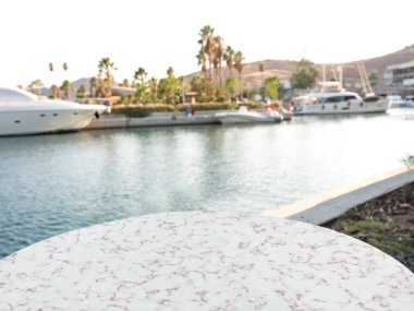 empty marble table in front of marina background, close up
