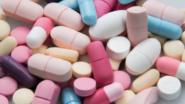 Different colored pills background, close up