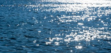 Surface of sea sparkling background, front view