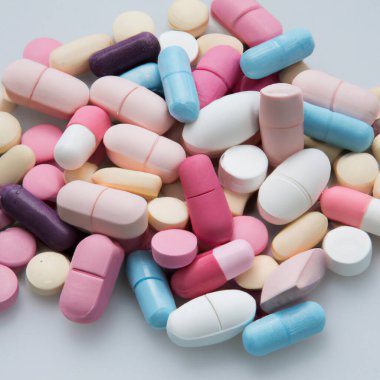 Different colored pills background, close up