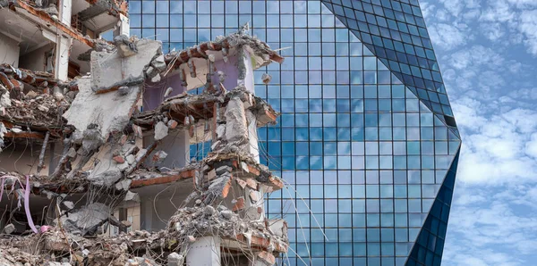 ruined house in front of modern skyscraper. Front view