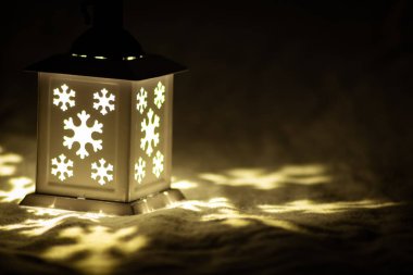 Romantik Noel ışıkları gecenin ilerleyen saatlerinde karanlık kutsal geceyi aydınlatıyor. Romantik Noel süsleri ve Noel süslemeleri ile.