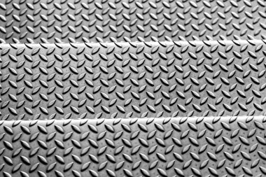 Som elmas metal plaka yüzeyi endüstriyel imalatta paslanmaz çelik döşeme gösteriyor. Metal merdivenler için steampunk arka plan ve ağır çelik plakalar korunmak için ve ağır zırhlı askeri araçlar için.